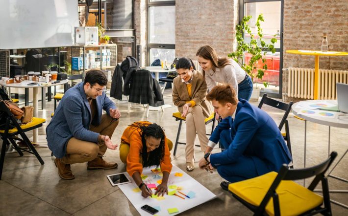 Project managers and employees brainstorming on ideas - Multi-ethnic group of workers having business meeting in a start-up office